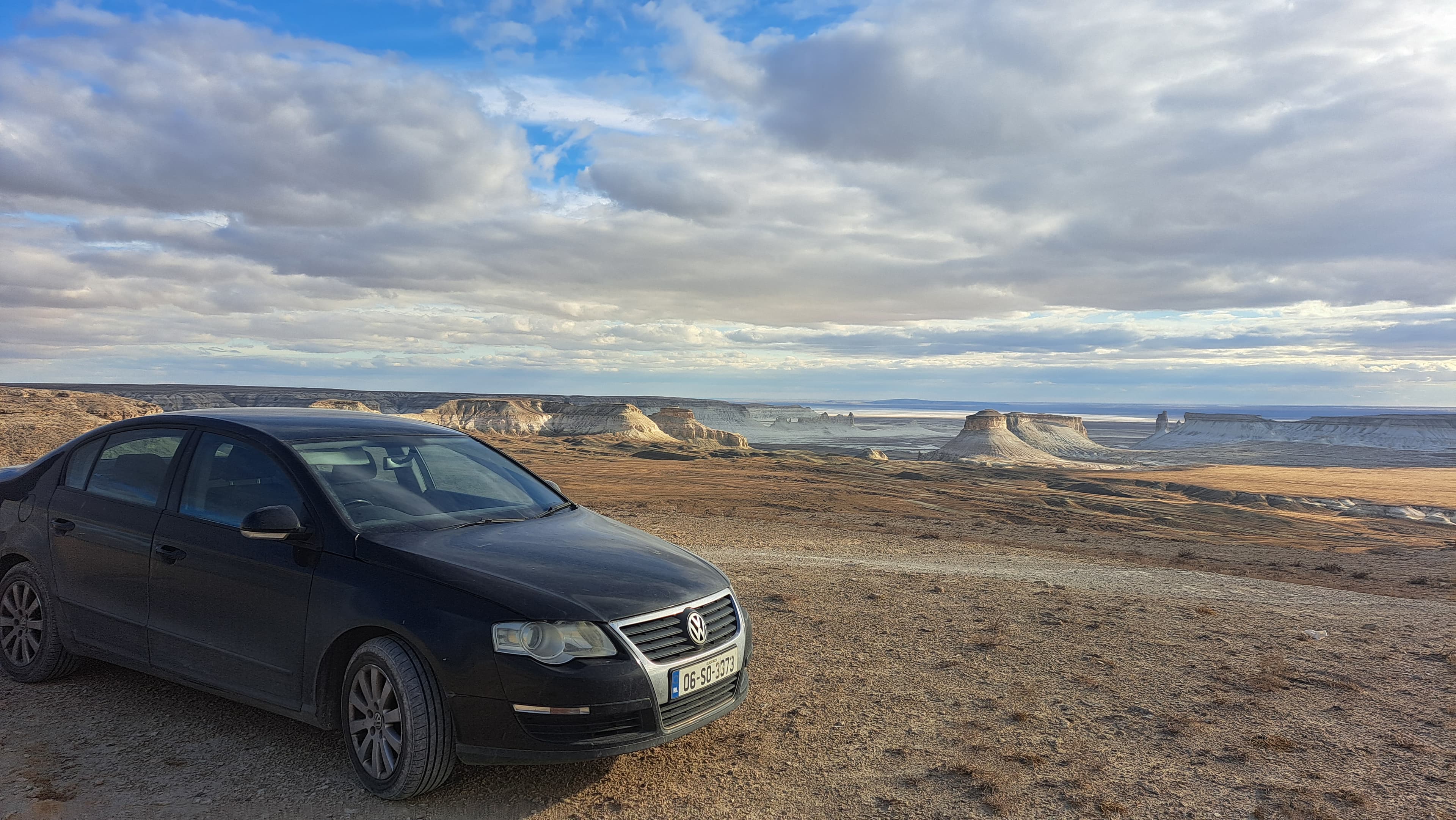 A travel car on a mountain highway at dusk